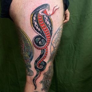 Get inked with an illustrative snake design on your upper leg by tattoo artist Andrea Furci.