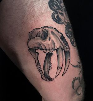 An illustrative blackwork skull tattoo on the arm, expertly done by tattoo artist Jethro Wood. A bold and striking piece of art.