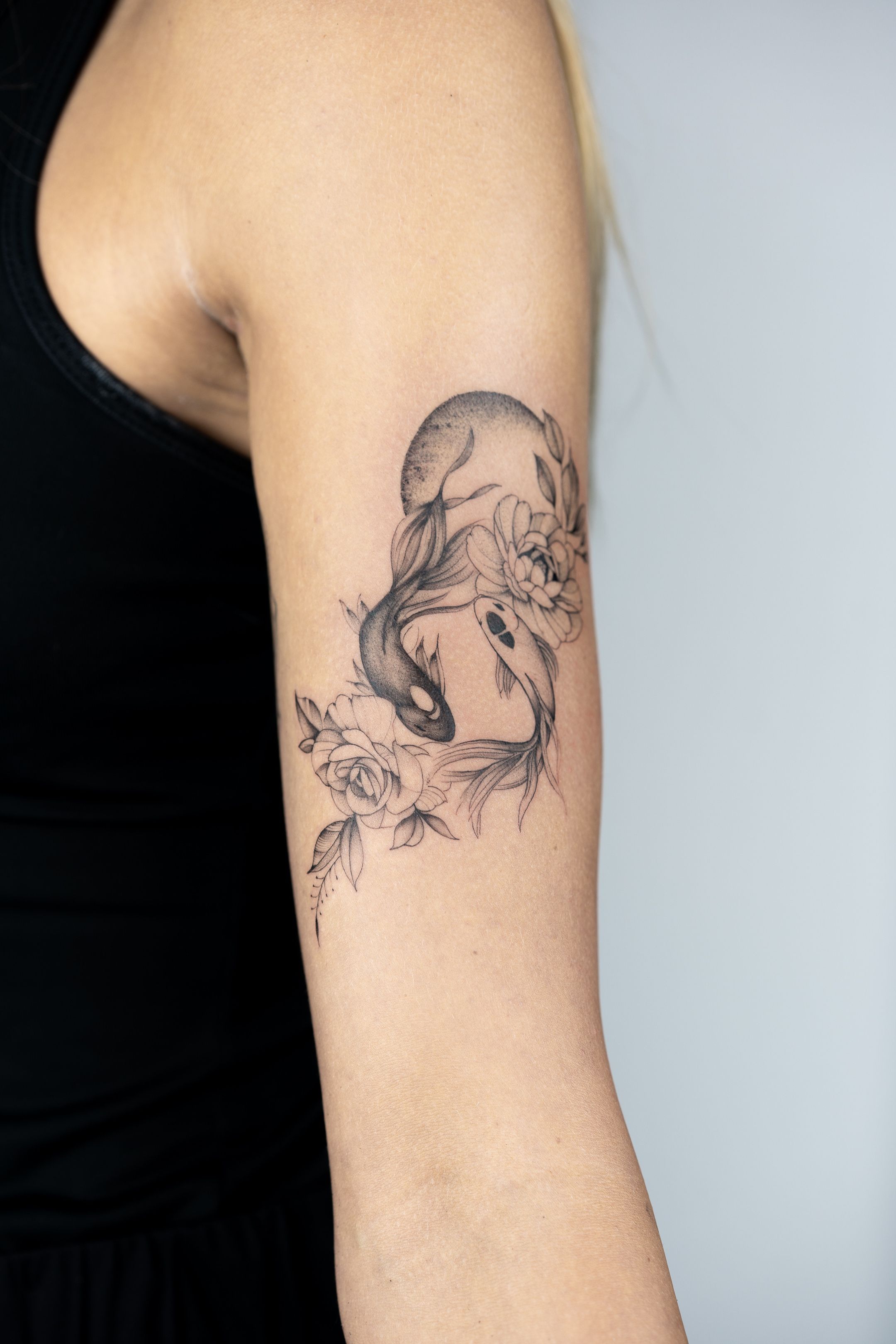 Tattoo uploaded by Jessica Coates • Two gorgeous koi carp with pretty lil  flowers, my first big tattoo ! Still debating whether to colour but I do  love just the black inc,