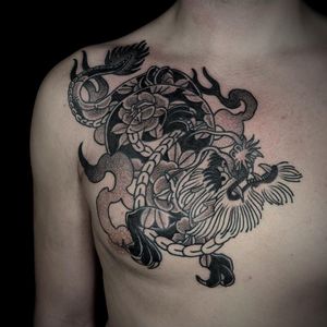 Lamat combines Japanese style with intricate dotwork to create a stunning dragon and flower chest piece. Explore the fusion of traditional motifs in this unique design.