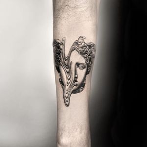 Experience the artistry of Oek with this stunning black & gray illustrative tattoo. Timeless and detailed, this piece is sure to make a statement.
