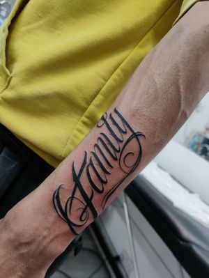 Beautiful lettering tattoo on forearm by Mary Shalla, symbolizing the everlasting bond of family love.