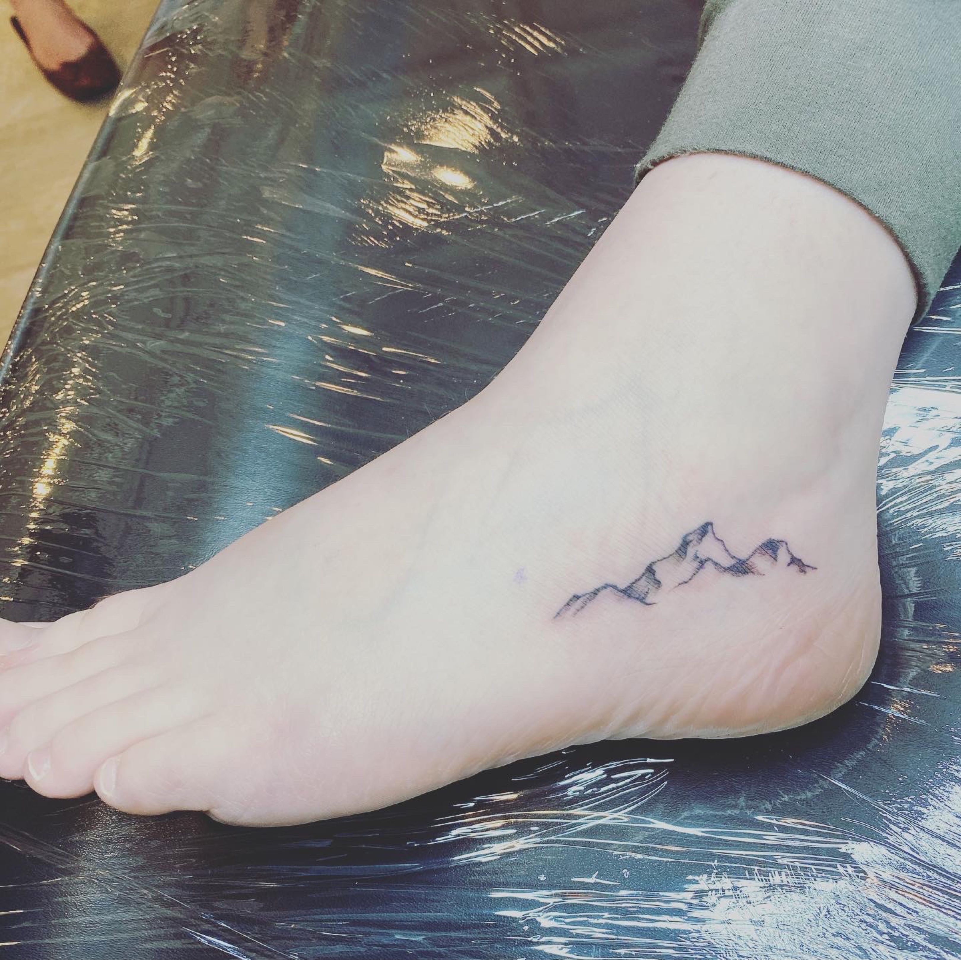Mountain tattoos on the right foot