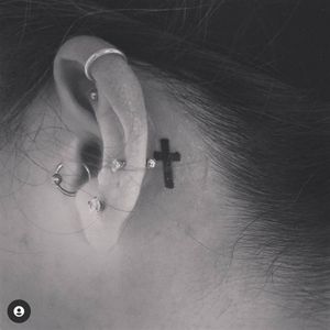 My friend took us out for tattoos. So I got a cross behind my ear. I always forget about this one.Can't even tell you who the artist was. But I do know it was my friend's normal artist who said he'd charge $20 for mine and ended up charging her $80.