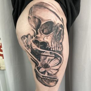 Skull thigh tattoo