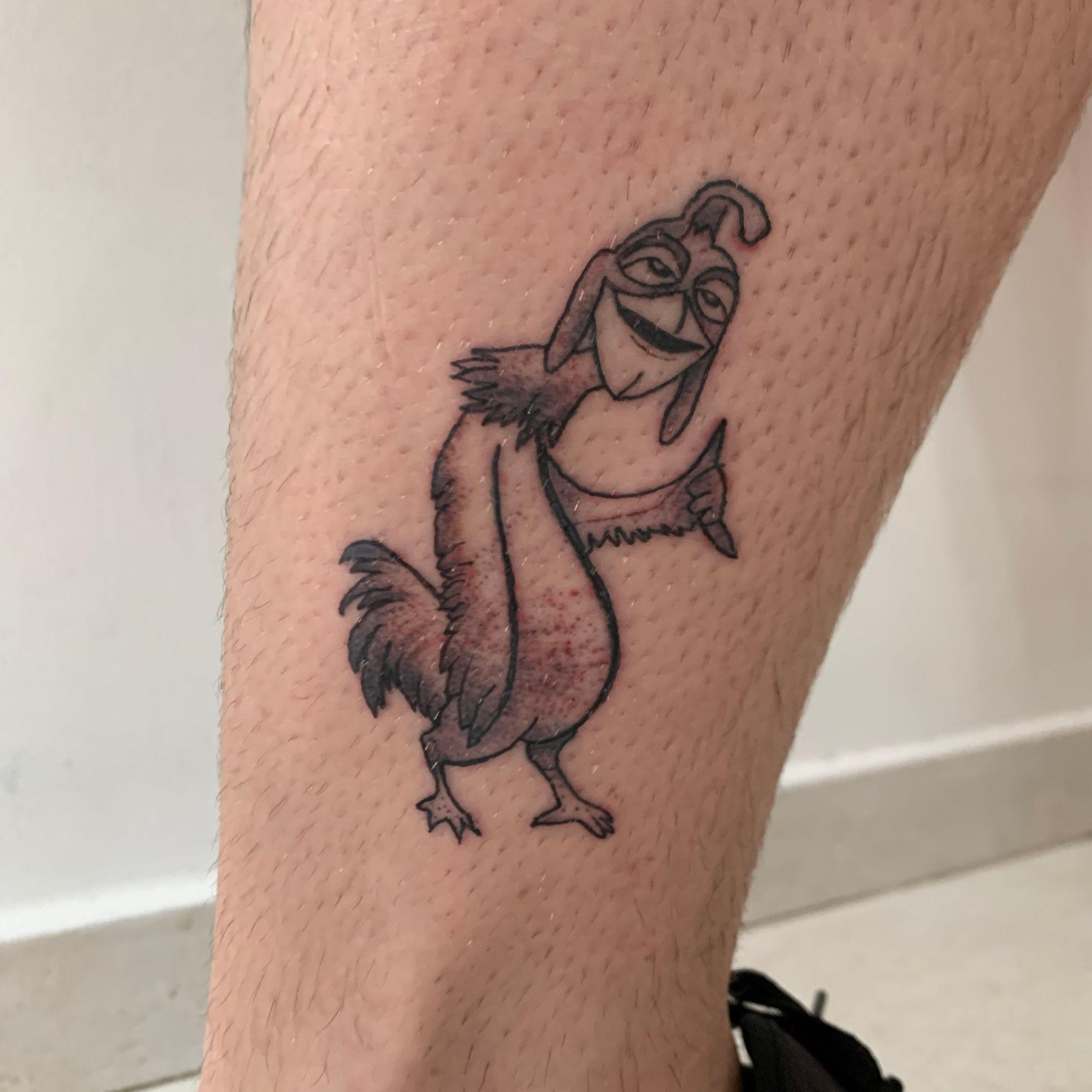 Chicken Joe from Surfs Up tattooed on the upper arm