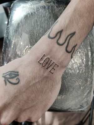 Beautiful small lettering tattoo on lower arm, designed by the talented artist Mary Shalla.