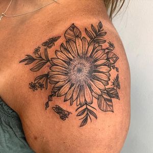 Embrace nature with this stunning blackwork illustration by Brigid Burke, featuring a bee and sunflower design on your shoulder.