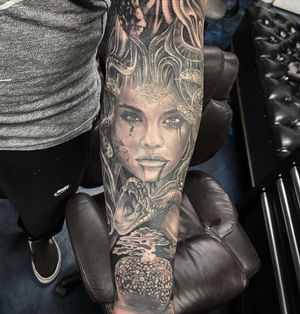 Black and gray masterpiece by Jake Masri, featuring a captivating Medusa design on the forearm.