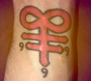 One of my first tattoos. Location: left wrist Subject: Alchemical sign for sulfur w/ 666 below it. 