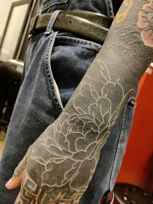 Beautiful blackwork flower tattoo on the forearm by Mary Shalla, showcasing intricate and bold design.
