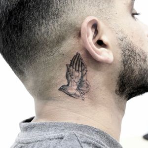 Get a stunning blackwork hand design tattooed behind your ear in Los Angeles. Detailed fine line work for a unique and spiritual look.