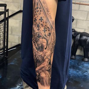 Get a stunning blackwork tattoo of an angel on your forearm by expert artist Jake Masri.