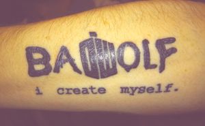 Dr Who tattooLocation: Left forearmSubject: “BaDWolf” with the DW symbol for the “D” and “W”, “I Create Myself” written below.