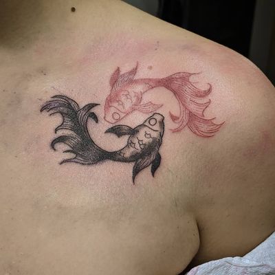 Elegant koi fish tattoo on shoulder by artist Luca Salzano, featuring intricate fine line details.