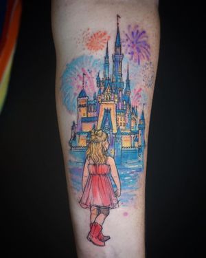 Vibrant watercolor design of a Disney castle with a girl, beautifully done by Aygul on the forearm.