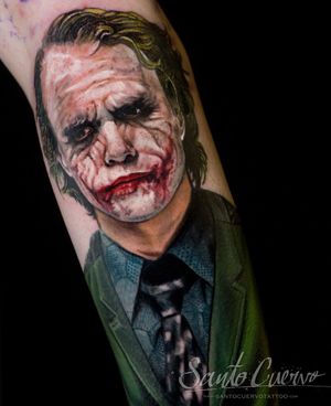 Incredible arm tattoo by artist Alex Santo capturing the iconic portrayal of Joker by Heath Ledger in a stunning realism style.