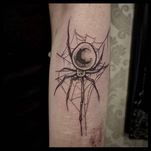 Detailed black and gray fine line tattoo of a moon and spider by artist Luca Salzano.
