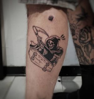 Unique blackwork and new school style lower leg tattoo by Luca Salzano featuring a grim reaper riding a skateboard.