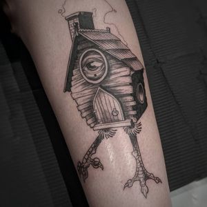 Experience the magic of micro_realism with this black_and_gray tattoo featuring a surreal cabin and captivating eye by artist Luca Salzano.
