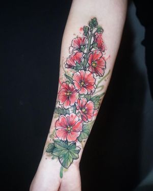 Express your style with Aygul's stunning watercolor flower tattoo on your forearm. Stand out with this vibrant piece of art!