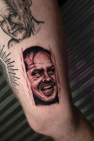Illustrative tattoo on upper leg by Miss Vampira capturing the iconic madness of Jack Nicholson. Dark and captivating.