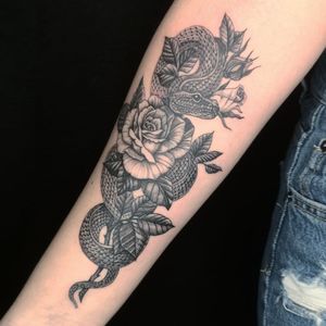 Elegantly designed black_and_gray tattoo by Fernando Joergensen featuring a snake entwined with a beautiful floral motif.