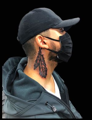 Feathers neck tattoo by Andre