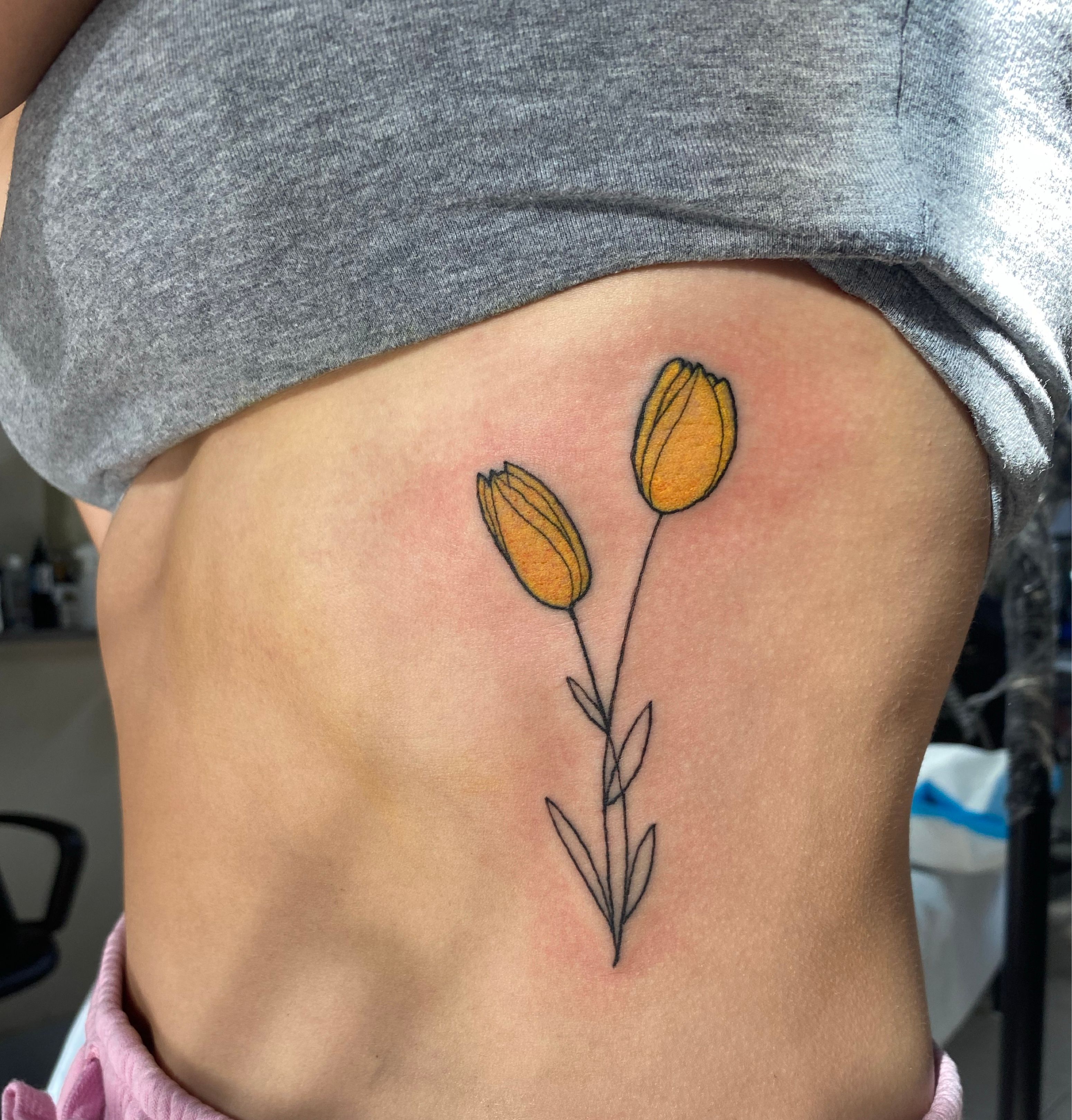 Sioux Falls Tattoo Floral Tattoo Of A Rose Buds And A Sunflower With Black  And Gray Shading And Accent Red And Yellow On The Forearm – Starry Eyed  Tattoos and Body Art