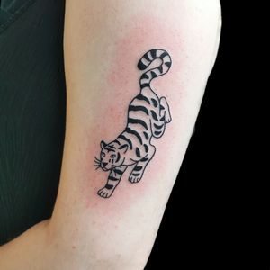 Minimalist tiger tattoo by Roxy at Camden Piercing and Tattoo Studio. 
