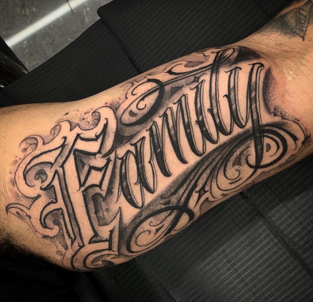Family lettering tattoo on the bicep