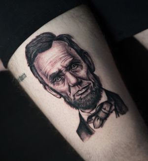 Embrace the horror and realism with Miss Vampira's chilling depiction of Abraham Lincoln on your arm. Dare to stand out with this unique blackwork design.