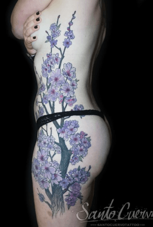 Get a stunning illustrative tree and flower tattoo on your ribs in London, GB. Elevate your body art with this unique design.