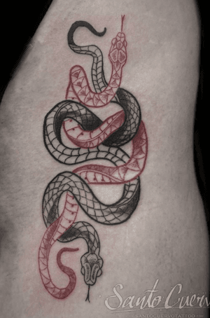 Get a bold and classic traditional snake tattoo on your ribs in London for a timeless and edgy look.