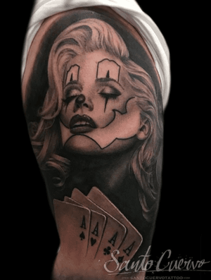 Get a stylish tattoo featuring a clown, casino, and woman on your upper arm in London. Perfect blend of chicano and realism styles.