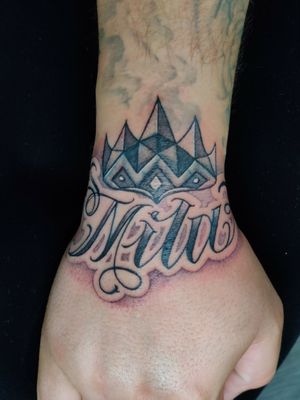A cover-up of some mountains with a crown. And free hand writing.
