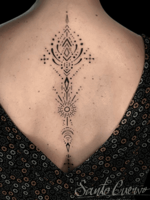 Discover the beauty of dotwork in this intricate ornamental pattern tattoo on the upper back in London, GB.