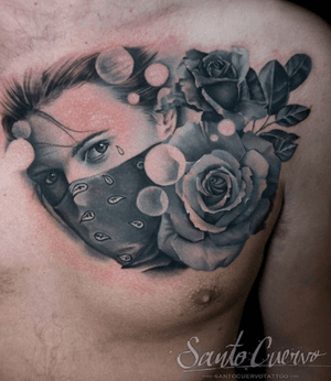 Realistic black and gray chest tattoo featuring a stunning flower and woman design. Get inked in London, GB!