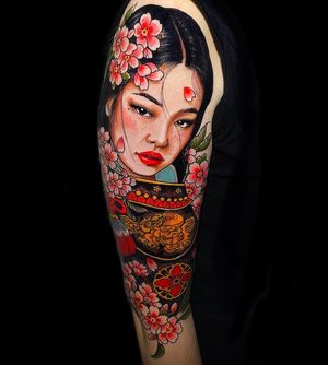 Capture the beauty of Japan with a stunning sleeve tattoo featuring intricate cherry blossom flowers and a graceful woman. Perfect for those in London, GB.