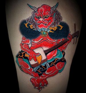 Get a stunning Japanese style tattoo featuring a guitar, raijin, and horns on your upper leg in London, GB.