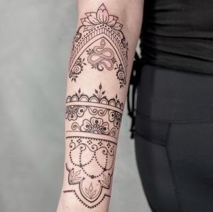 Blackwork mandala pattern tattoo on forearm in Los Angeles. Beautiful ornamental and illustrative design.