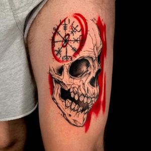Get a bold and edgy trashpolka tattoo featuring a skull and compass motif on your upper leg in London, GB.