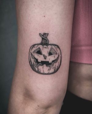 Get in the Halloween spirit with this blackwork pumpkin tattoo on your upper arm in Los Angeles.