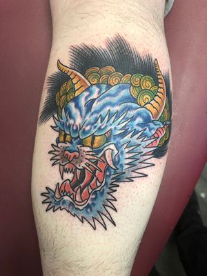 Get a fierce and majestic Japanese dragon tattoo on your lower leg by the talented artist Shawn Nutting.
