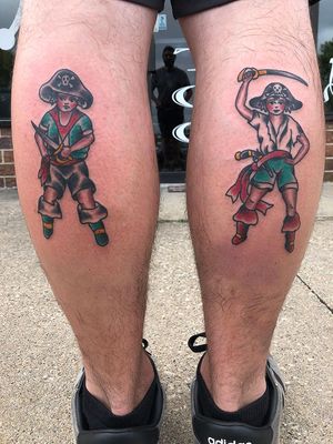 Illustrative traditional tattoo on lower leg by Shawn Nutting featuring a pirate hat and sword motif.