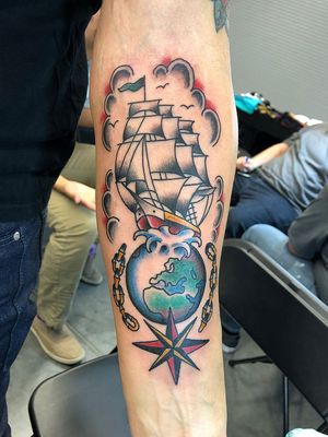 Beautiful forearm tattoo featuring a traditional design of a star, ship, and world, created by Shawn Nutting.