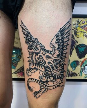 Get a stunning blackwork illustrative tattoo of a tiger with wings on your upper leg in Los Angeles