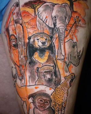 Experience Aygul's stunning watercolor work on your upper leg with this playful elephant and monkey tattoo.