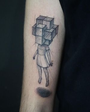 Exquisite upper arm tattoo featuring a girl in a dress surrounded by a cube, done in fine line style by artist Aygul.
