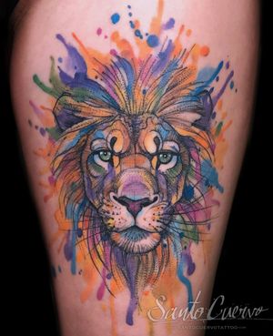 Experience the fierce beauty of a watercolor lion tattoo with sketchwork details on your upper leg, by the talented artist Aygul.